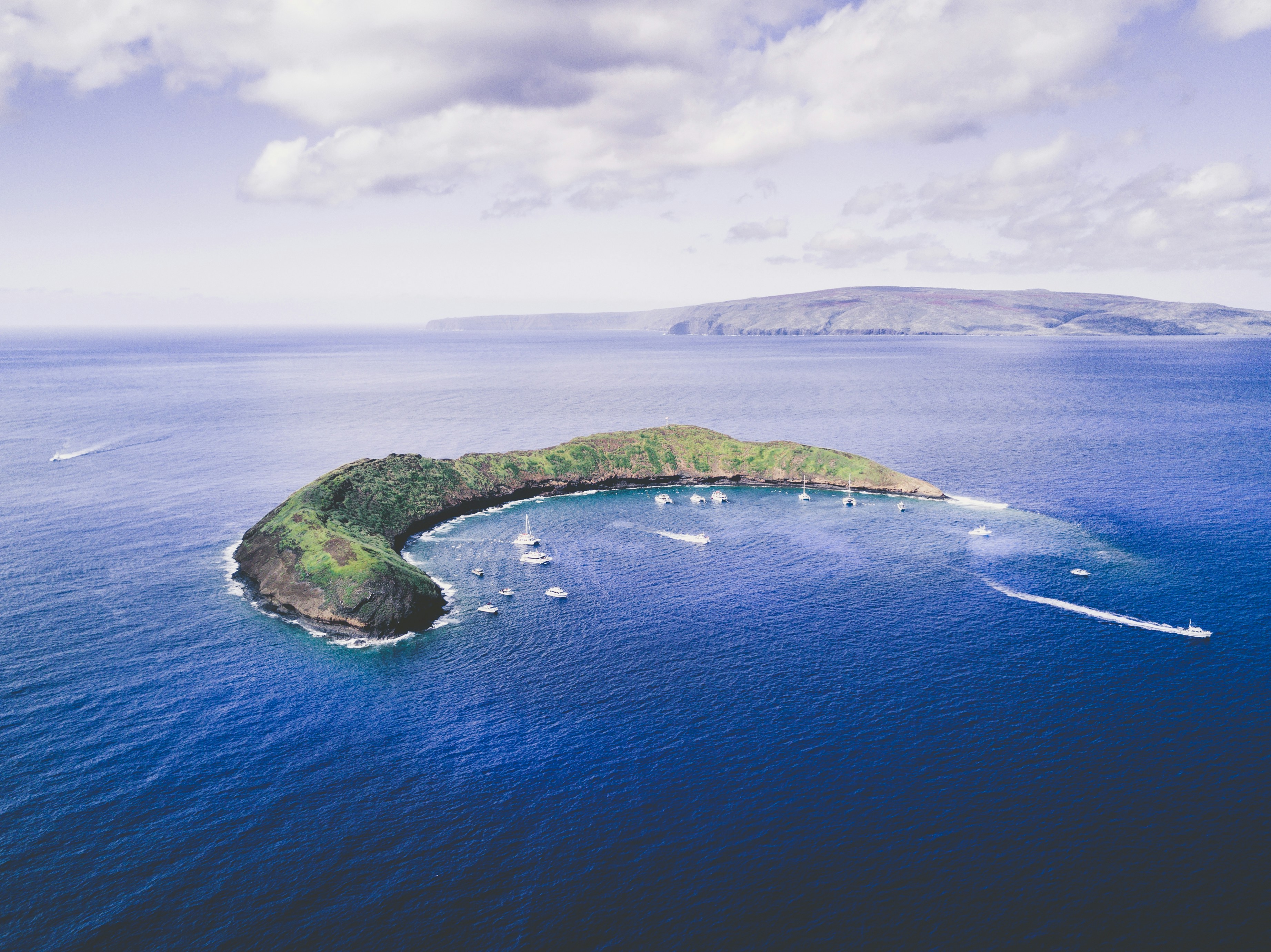 Aerial view of Molokini Crater with boats, Maui Hawaii